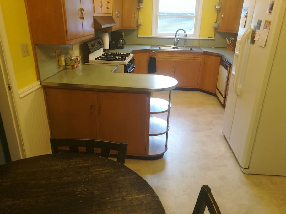 Full kitchen with all appliances and a small four person table.