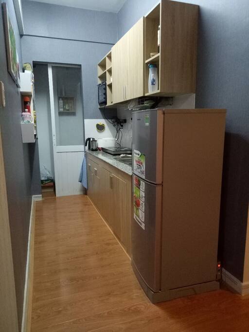 The kitchen with electric cooker and frigde, pots, Pan, kettle...