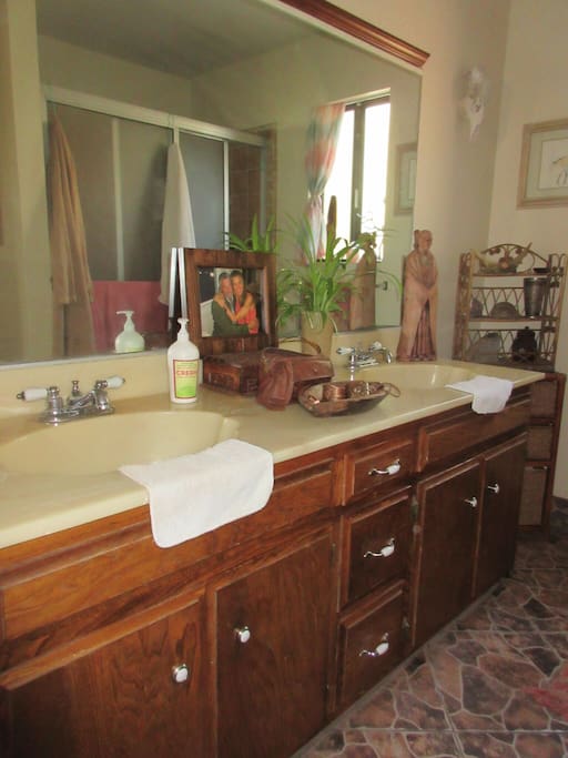 Private bathroom has large shower & two sinks.