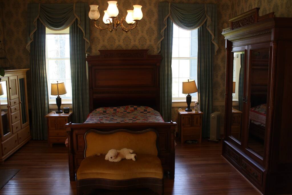 Master Bedroom with fireplace and gorgeous wood floors.