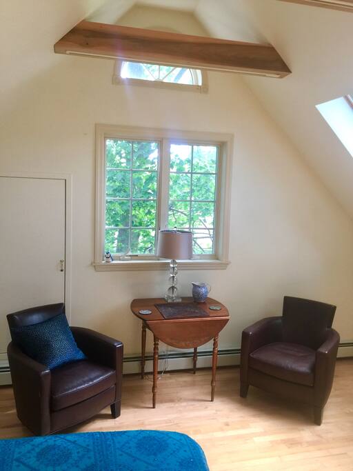 Sitting area with two leather chairs and a table.