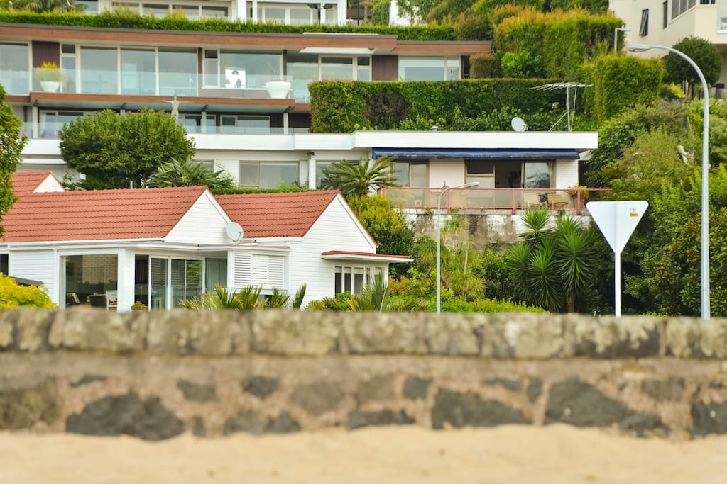 House just across the road from the beach ( Blue awning )
