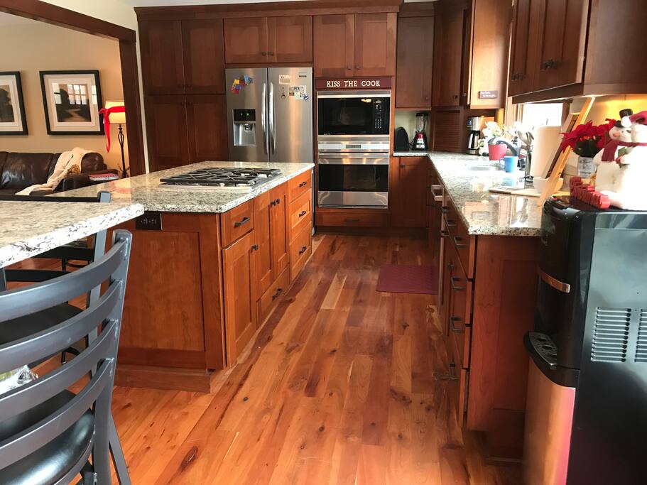 Kitchen- 6 unseen stools at breakfast bar (in addition to the other bar.) Large picture window over sink featuring beautiful private yard with lake view.