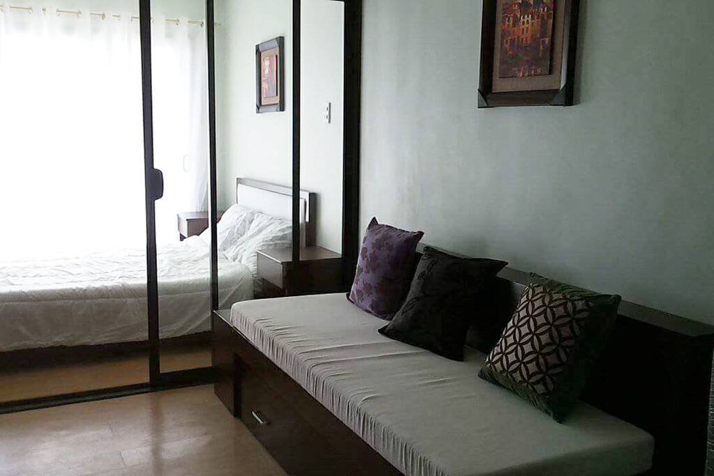 The sofa bed with pull-out can accommodate two pax. The living area leading to the bedroom is separated by clear glass covered by curtain.