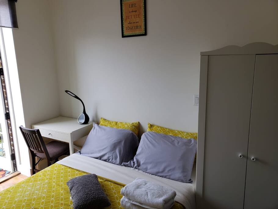 Queen bed with closet, desk and lamp