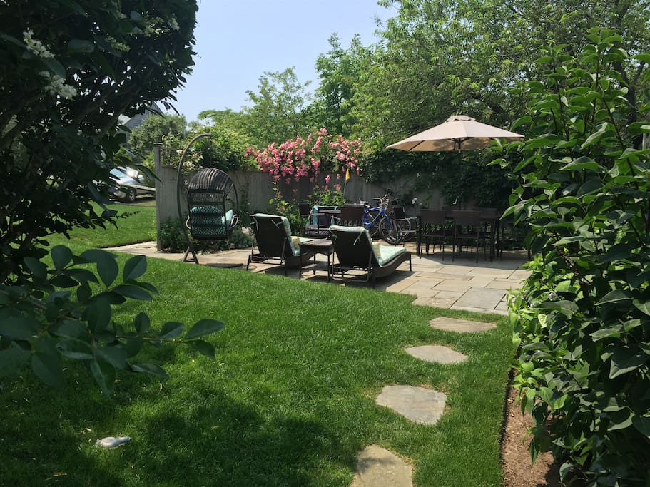Back yard and large, private blue stone patio with grill.