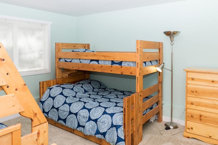 Downstairs bunk room features two bunk beds with stair access, doubles on the bottom, twins on the top.