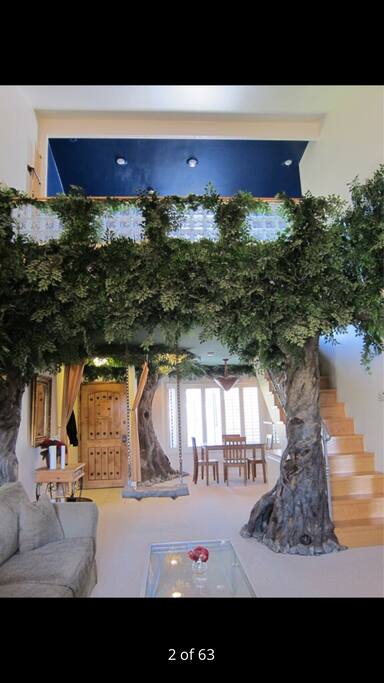 An urban treehouse retreat with an upstairs loft (bedroom) and a master bedroom.