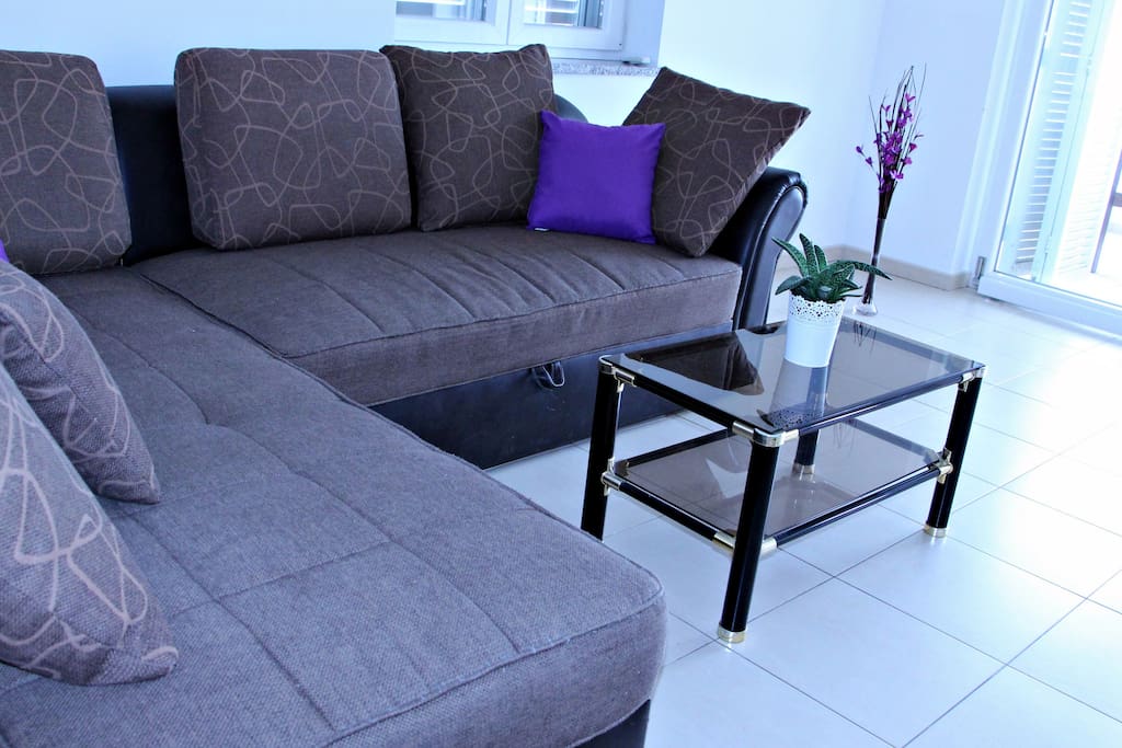 Living room with sofa for two and a table.