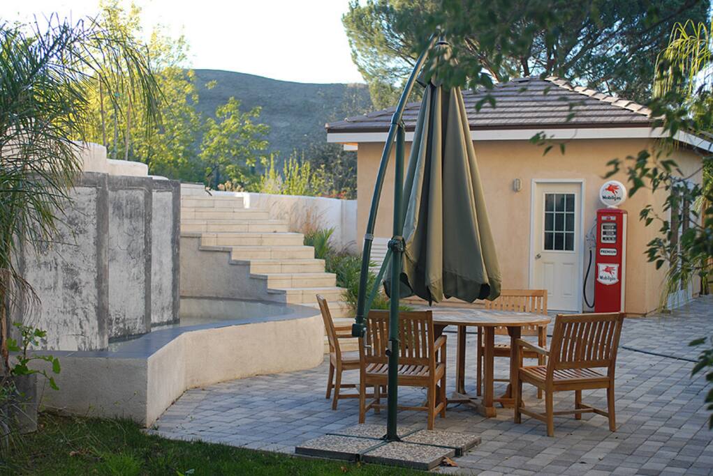 Large paver stone back patio with Water Fall feature pond perfect for posing models in front of the walls with sheets of water running down.