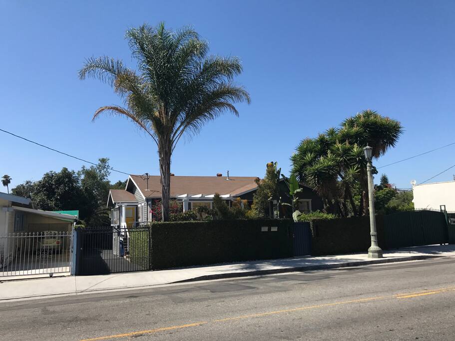 Street view. Each side has one parking spot in back for small compact car no SUV’s will fit. Driveway is narrow. Driveway gate is motorized and you will be supplied with an opener during your stay.