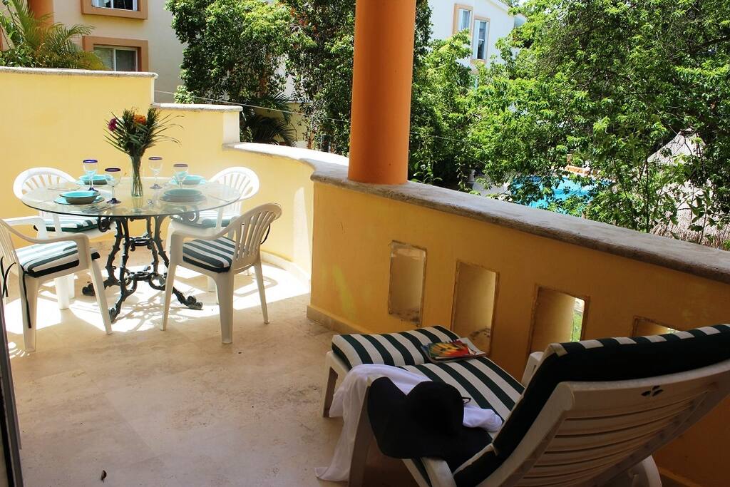 The terrace has furniture, and view to the pool