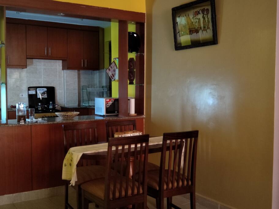 Open plan kitchen and a dining table .