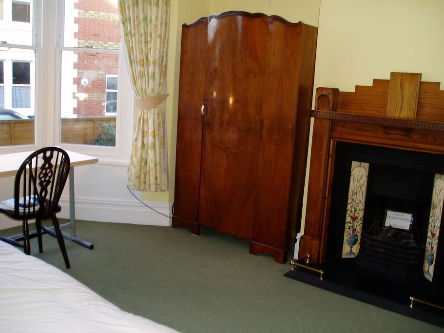 Lovely period furniture and fireplace.