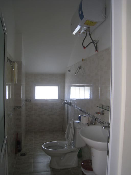 Toilet and shower inside top floor bedroom