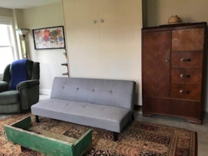 Lay the futon flat and pull down the queen sized Murphy bed. Chifforobe provides clothing storage.