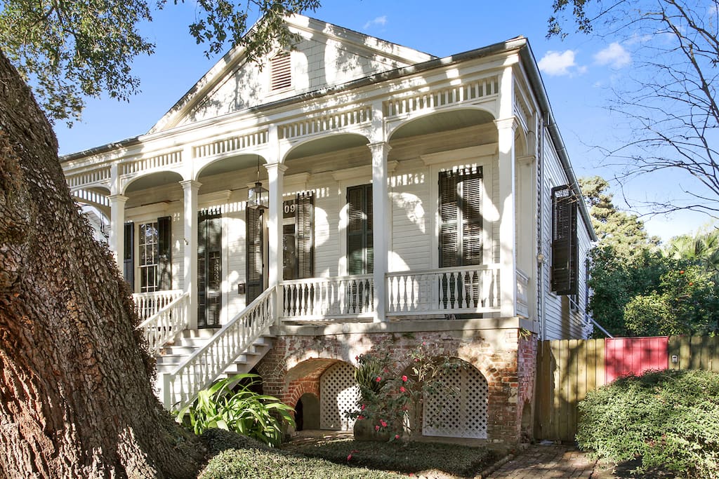 View of the red entrance gate and enormous live oak tree