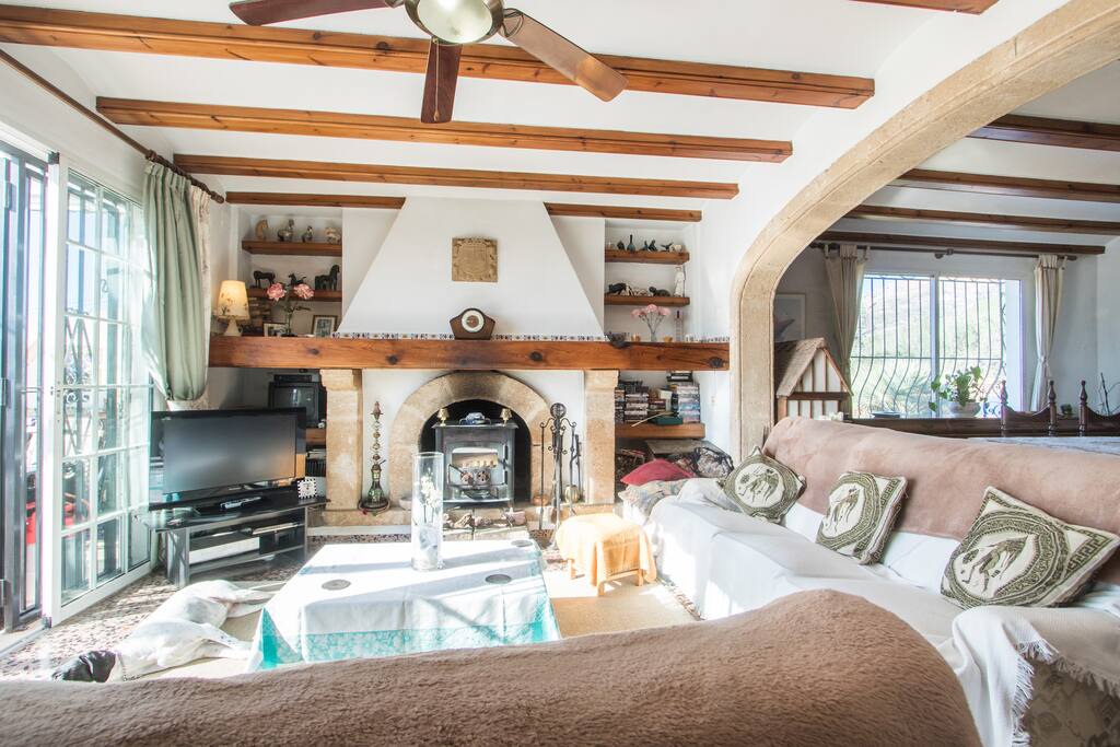 Lounge area with fire place, TV and comfy sofas