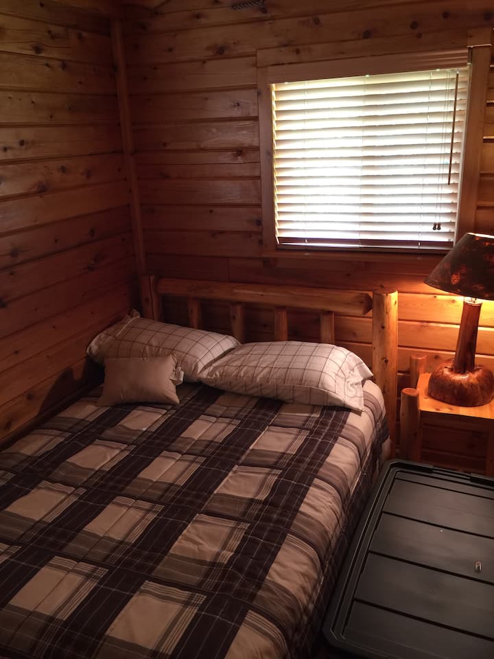 Queen size bed in second bedroom downstairs.