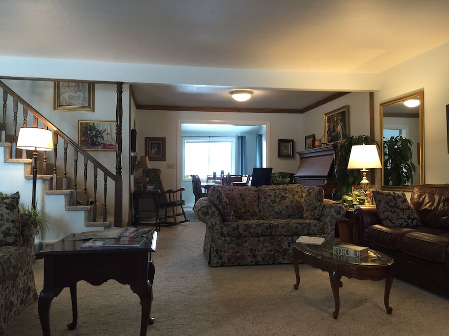 The living room opens up to a music area and dining room.