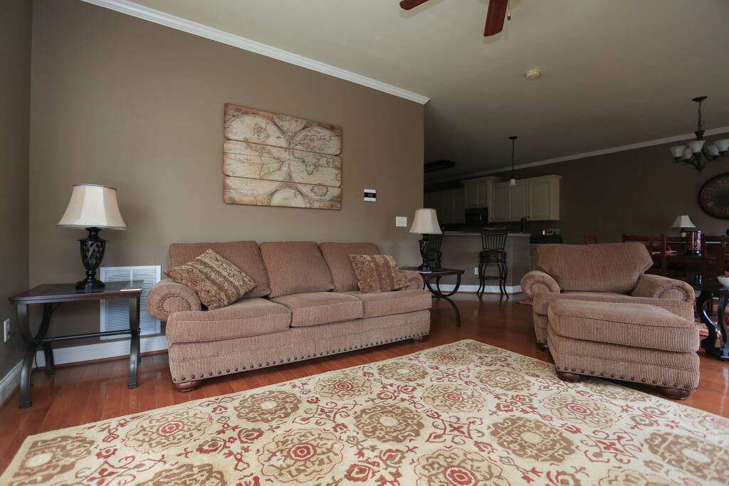 Living Room which has a couch, chair with ottoman and another chair(not shown in picture)