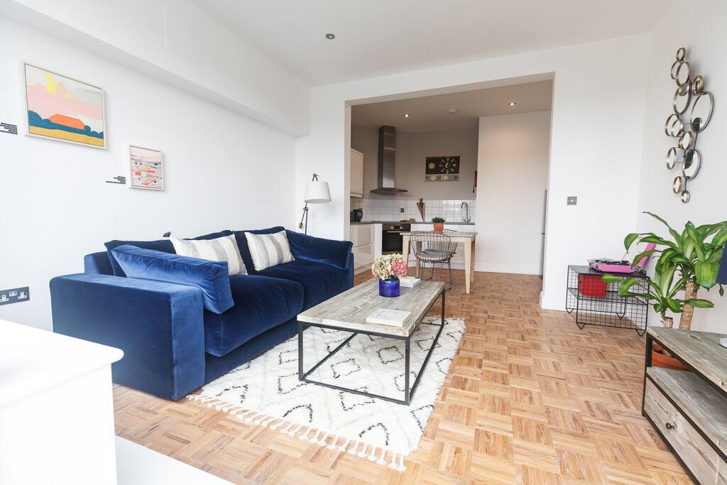 Large open plan kitchen, dining, living room, with herringbone parquet flooring throughout