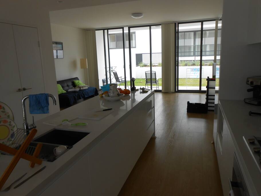 fully equipped kitchen looking thru lounge to back yard