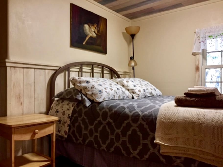 Open concept bedroom with cozy double bed