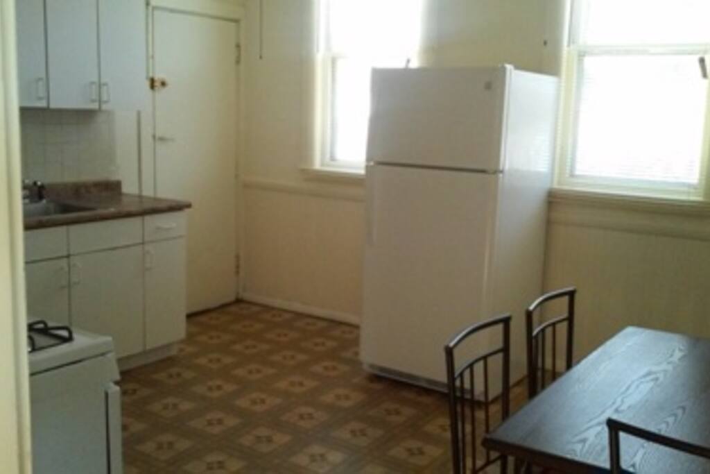 Kitchen view showing: 2 Windows, Refrigerator, 2 Piece Dining Set,
Stove, Kitchen Sink including Pantry