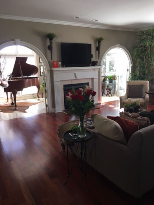 Gorgeous living room and sunroom. Grant piano to play
