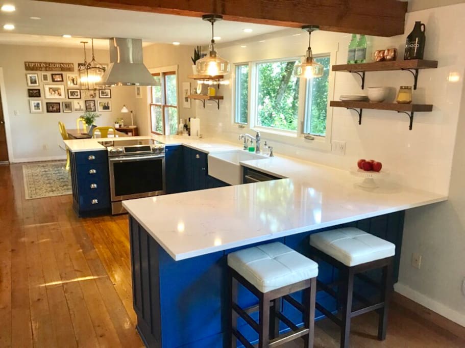 Newly renovated kitchen is the heart of the house; centrally located, with bar seating on both sides, lots of windows, make it a functional , social and bright space.