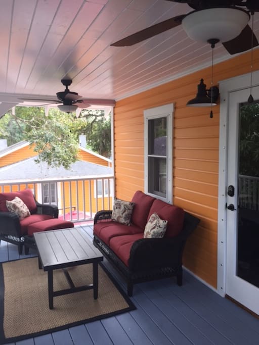 Outdoor porch captures Florida breezes while guests relax in the shade
