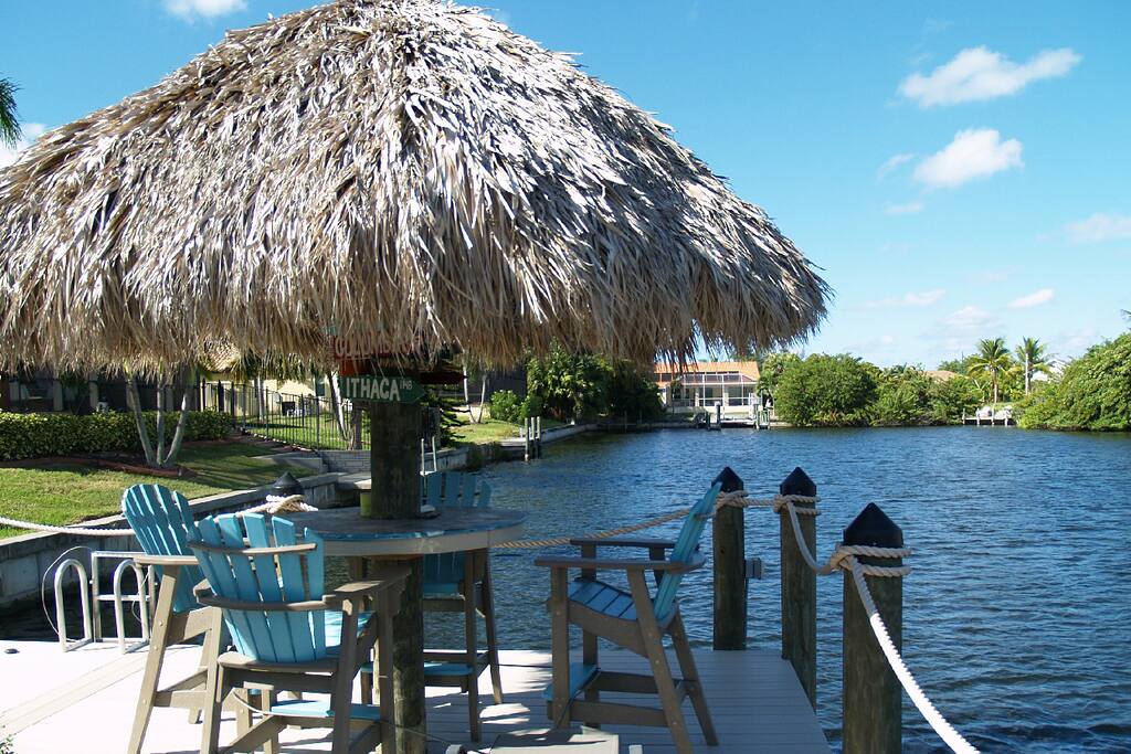 Tiki on dock with Adirondack style bar chairs for evening cocktails.