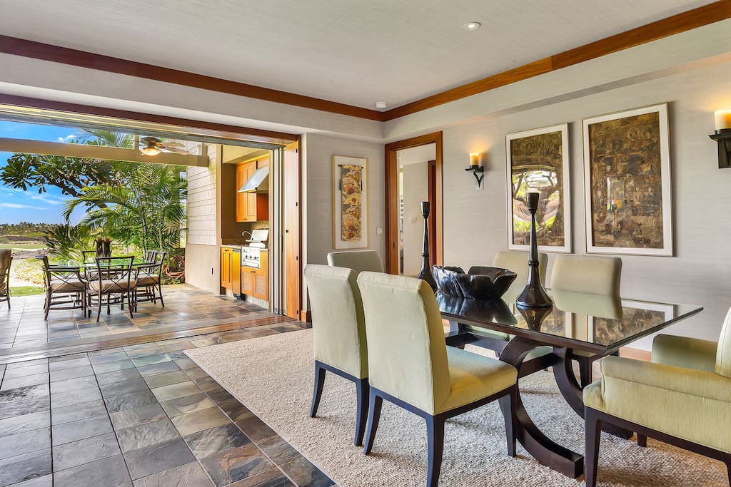 Elegant dining area, floor to ceiling pocket doors open out to the lanai
