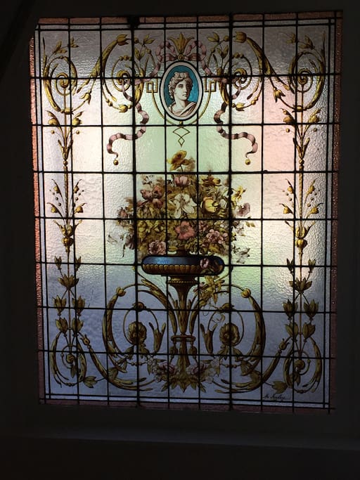 A vintage 1900 stained glass in the wide staircase