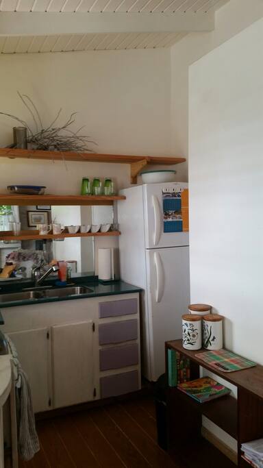 Your kitchen view 1. A mirrored back splash, Corian counter top fridge and small stove.