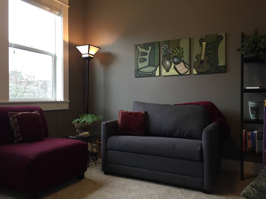 Private sitting room, across the hall from the bedroom, with twin couch/sofa-sleeper, coffee, tea, refrigerator, yoga mats and props