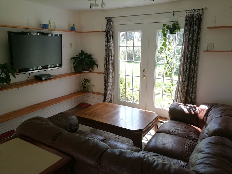 Welcome! The living room has a very comfy couch, coffee table, French doors to the back back yard, and TV with Apple TV, all hooked up!