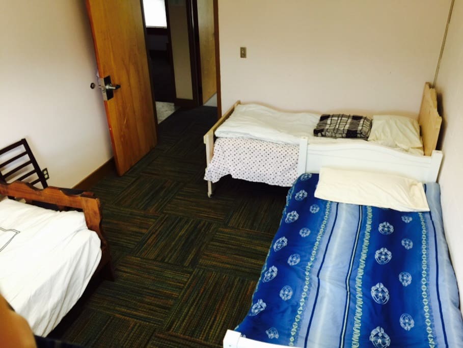 Three single beds in another room