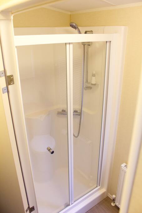 double shower ,toilet,sink and cabinet with mirror