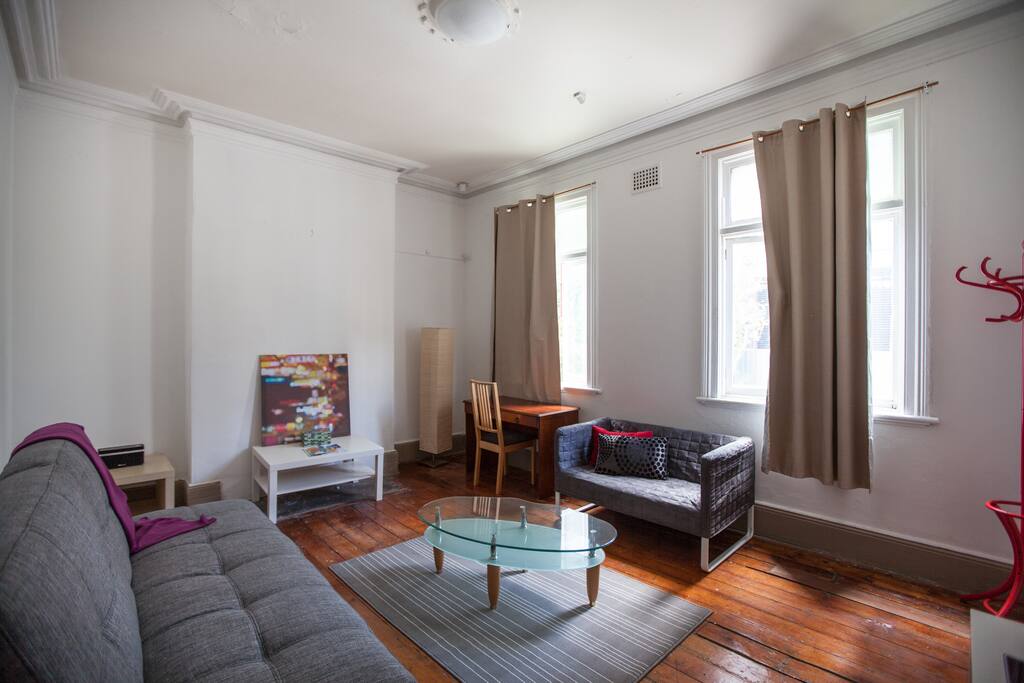 Lounge room with sofa bed, sofa, TV and office desk