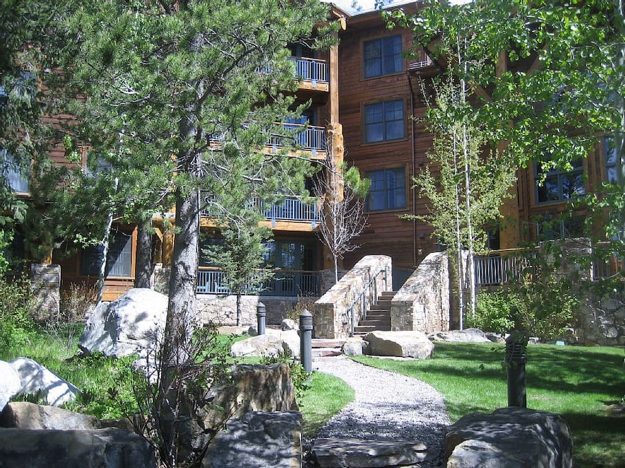 South facing view of grounds and stairs to the great room and main entrance.