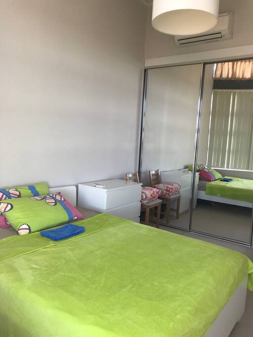 Queen bed, chair, bed sheets, pillow, blanket, drawers, wardrobe, and chair.