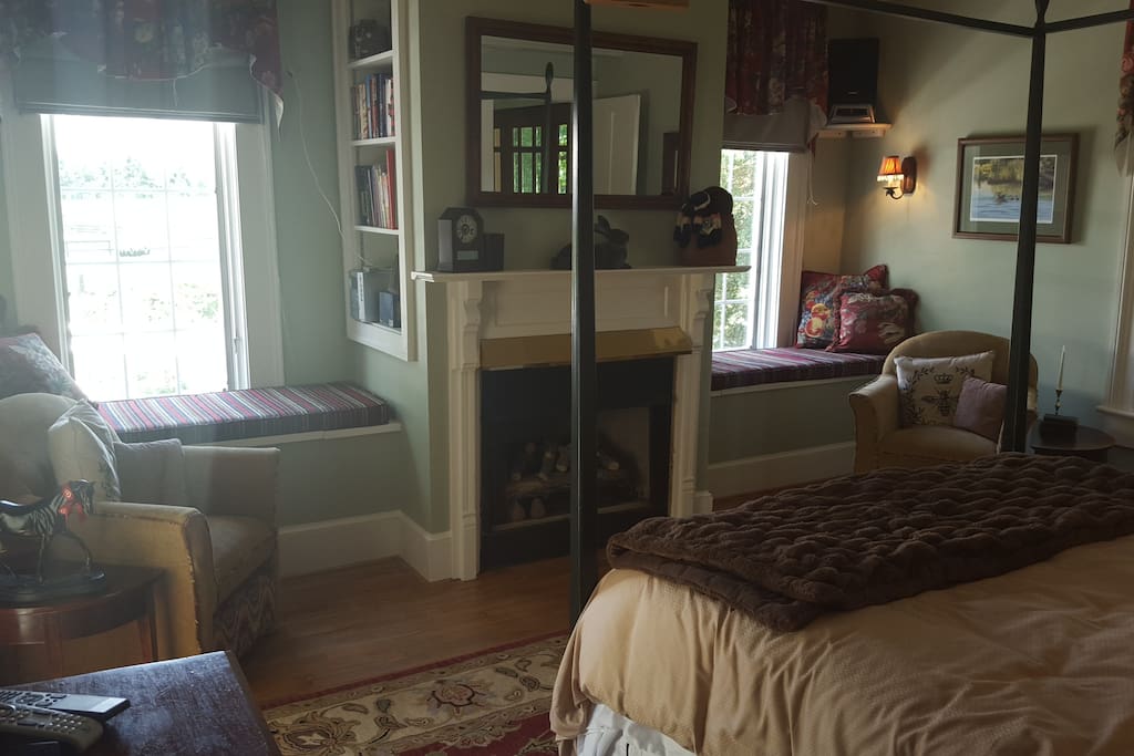 Window seats, chairs with ottomans, and electric fire place.