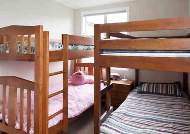 Third bedroom is a kids bunk room. 4 single beds and plenty of space for their bags. Block out thermal waffle blinds to keep it cool in summer and warm in winter.