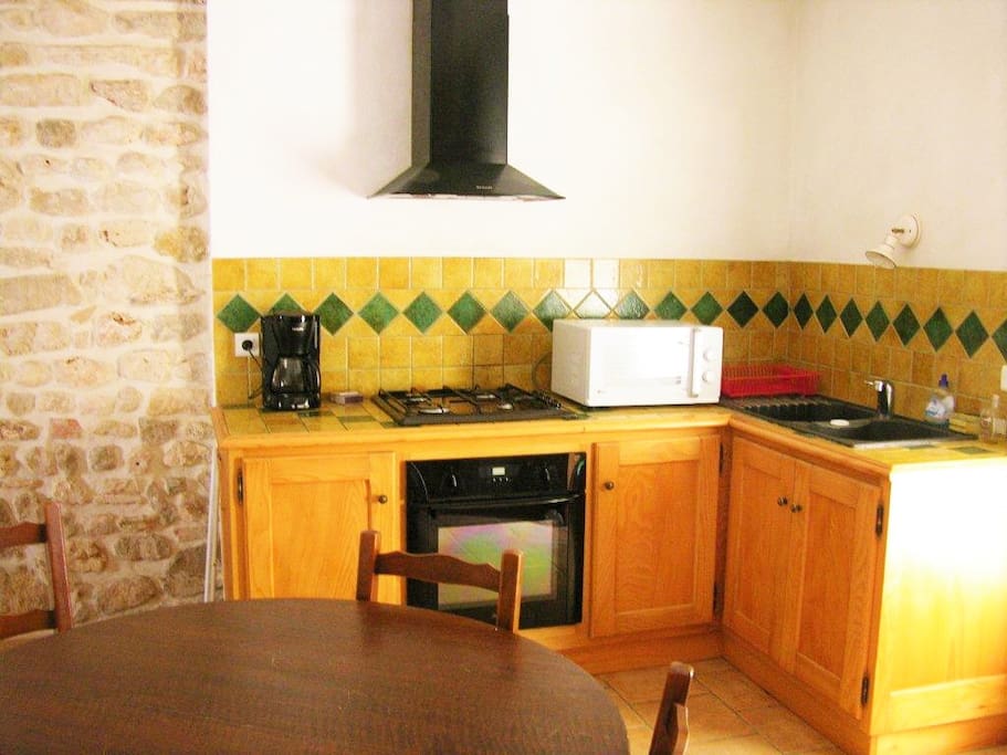 Kitchen opening onto the terrace and garden