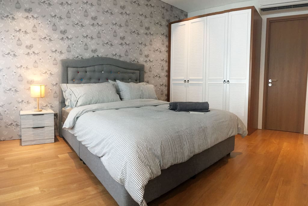 The master bedroom with a queen sized bed & plush pillows.