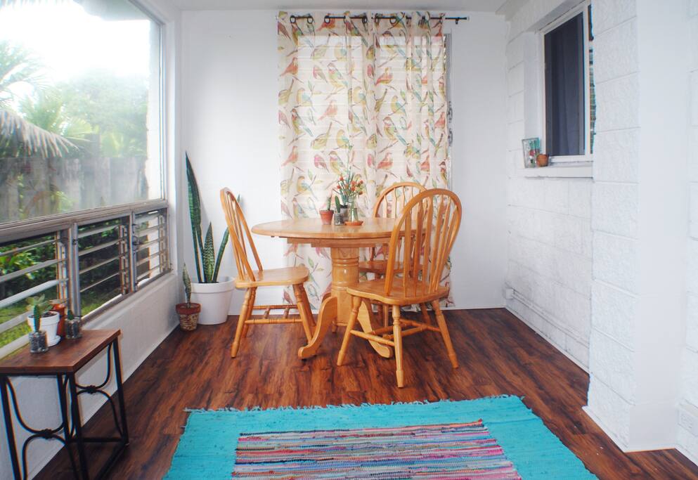 Sunroom with breakfast nook and a view of the front yard