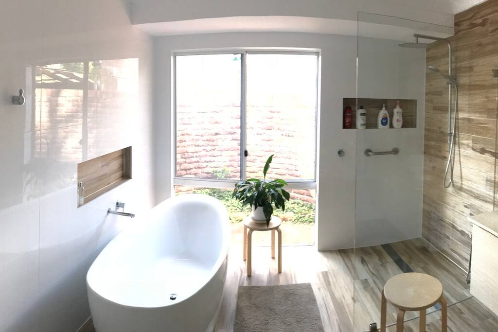 A brand new contemporary bathroom has a large reclining bath or try the rain head - walk in shower.
The floors are heated, with a heated towel rail and heat lamps.
Enjoy the privacy with an enclosed circle wall and a camellia and wild strawberry garden.