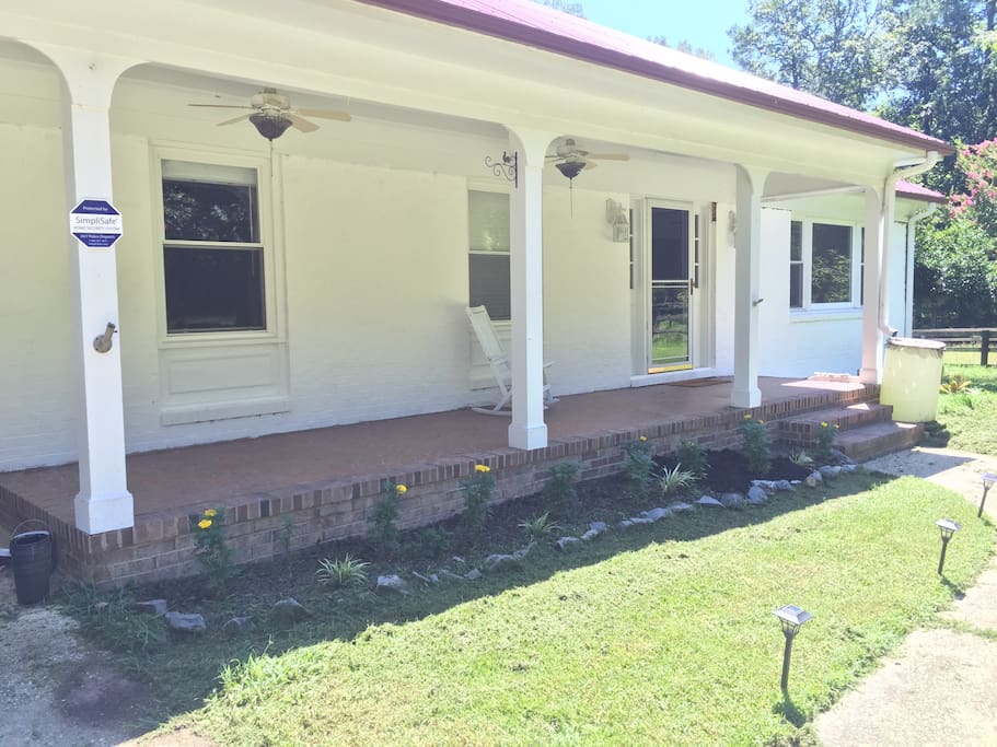 Cute white farmhouse with lots of charm and character! Enjoy the fans on the front porch as you enjoy iced tea on the rocking chairs!